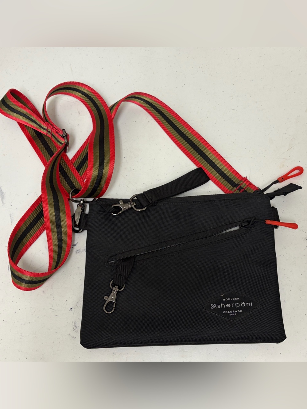 Sherpani Black Crossbody with Red and Green Striped Strap